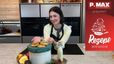 Sarah präsentiert in einer modernen Küche die fertigen Bratapfel-Cookies auf einer Dose sowie eine Flasche Vanillekipferl-Likör.
