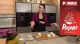 Tanja präsentiert in einer modernen Küche das „Rezept der Woche“: fertig gebackene Birnenküchlein mit schneeweißen Baiser-Spitzen, die in weißen Förmchen auf einem Holzbrett angerichtet sind. Die Moderatorin steht lächelnd hinter der Arbeitsplatte vor einer Küchenzeile mit Einbaubacköfen.